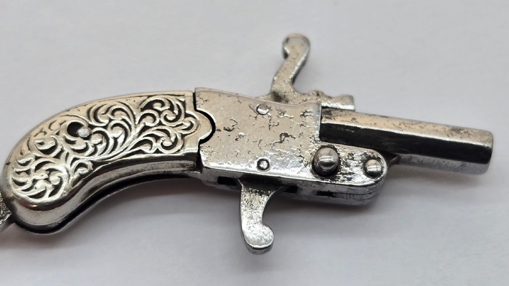A superb pocket watch chain fob in the form of a flintlock pistol

 View X