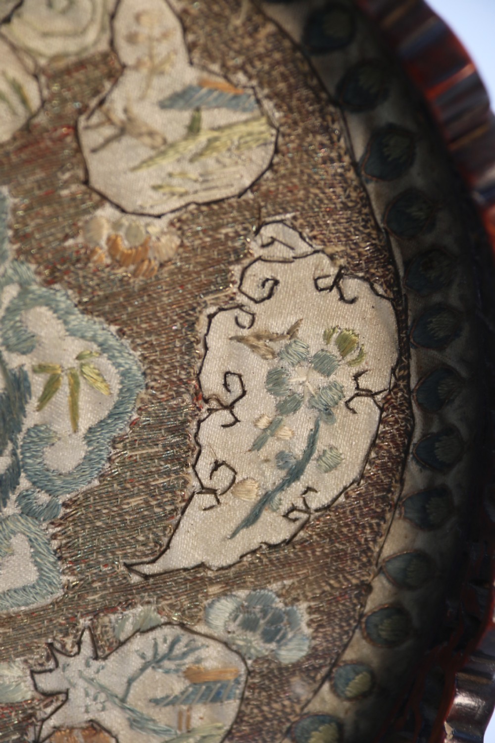A circular carved dark hardwood tray containing an inset 19th-century Chinese silk embroidery with figural and botanical motifs. View XVI