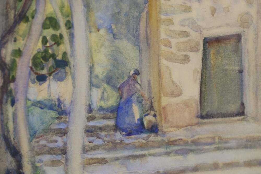 A framed 1920s watercolour landscape painting showing a stone building with vine foliage, set inside a decorative gilt frame with cream matting. View VIII