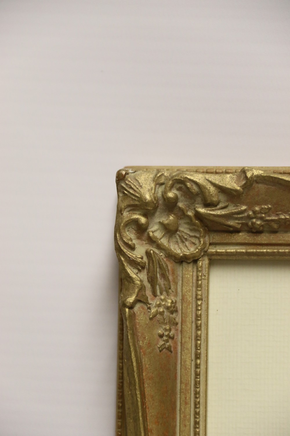 A framed 1920s watercolour painting depicting a sunlit Mediterranean building behind foliage, set within an ornate gilded frame. View VI