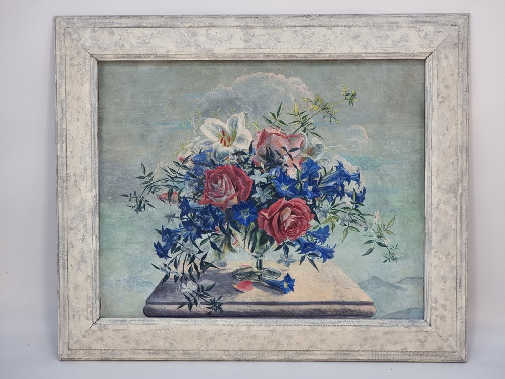 A framed mid-century tempera painting depicting a arrangement of red roses, white lilies, and blue flowers in a glass vase on a stone pedestal.