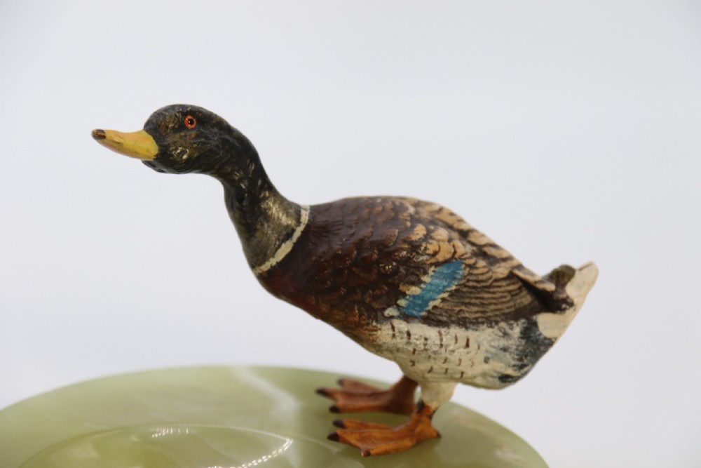 A cold painted bronze study of a mallard duck standing on the rim of a dished, circular green onyx base. View XI