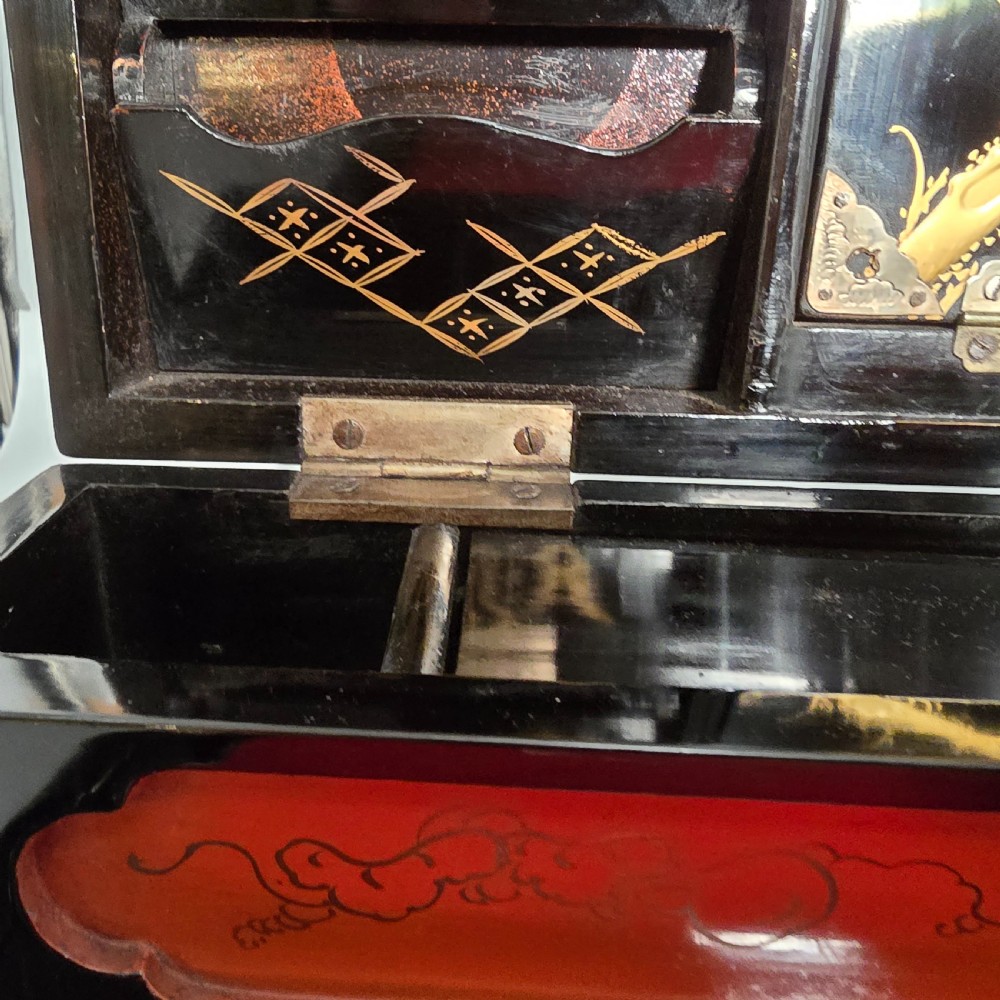 A black lacquer Japanese writing box decorated with detailed gold botanical and bird illustrations, featuring a hinged lid opening to internal correspondence slots. View XXVII