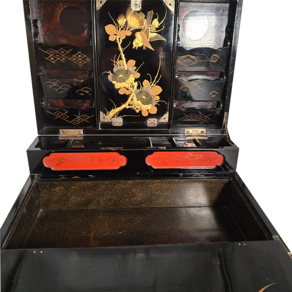 A black lacquer Japanese writing box decorated with detailed gold botanical and bird illustrations, featuring a hinged lid opening to internal correspondence slots. View XXIX