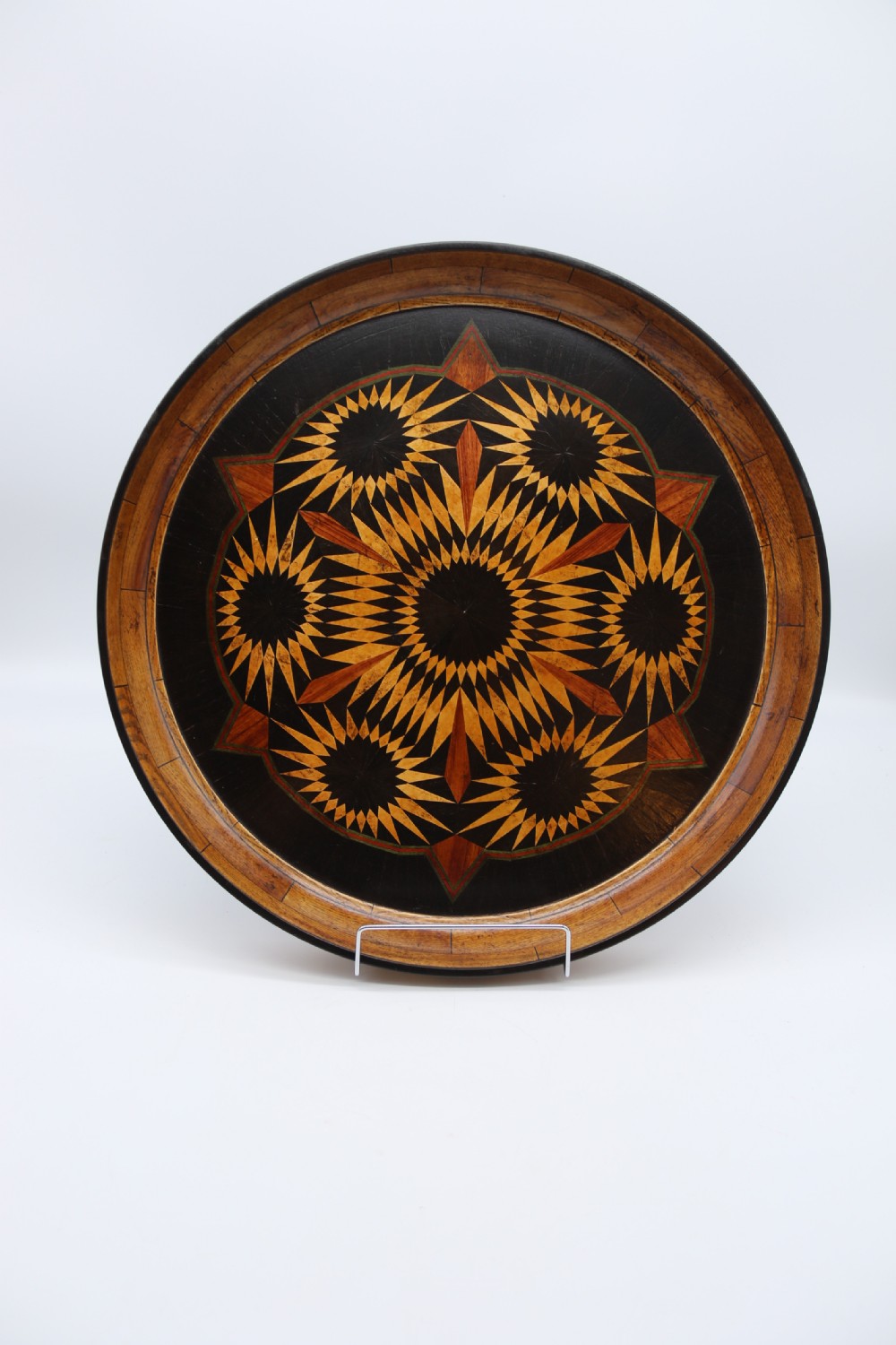 A large late 19th century circular aesthetic movement parquetry tray