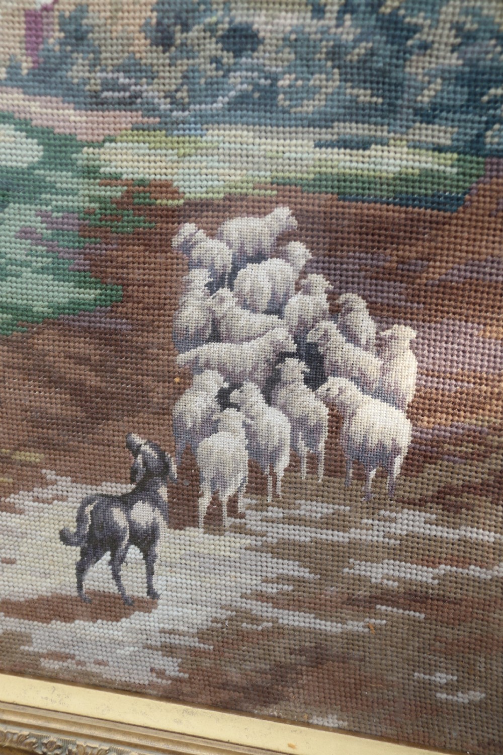 A large framed woolwork needlepoint tapestry depicting a pastoral landscape scene enclosed in a heavily ornamented giltwood frame. View VIII