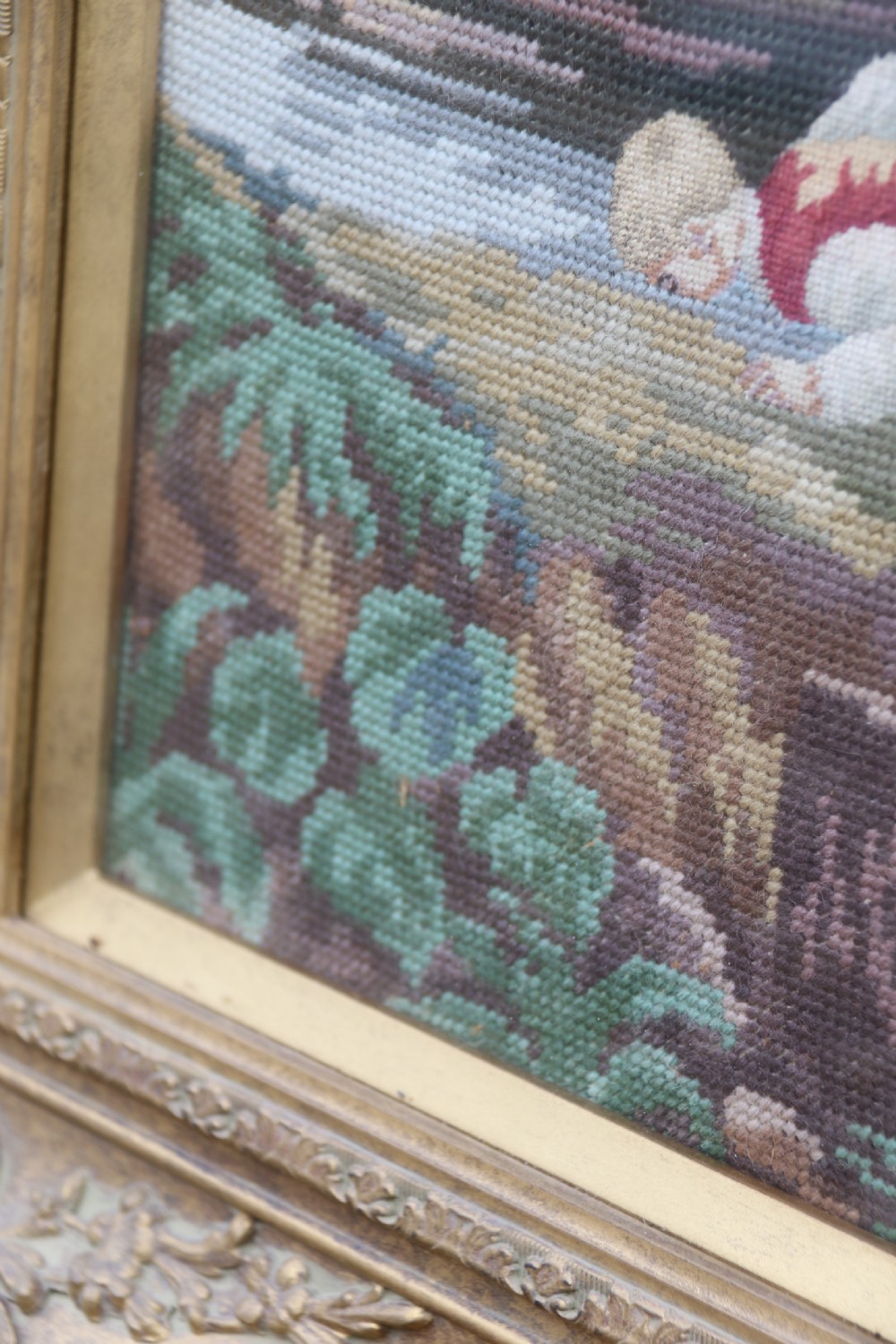 A large framed woolwork needlepoint tapestry depicting a pastoral landscape scene enclosed in a heavily ornamented giltwood frame. View X