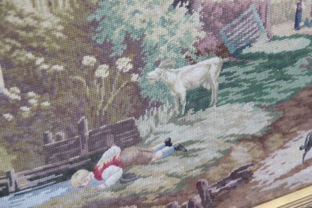 A large framed woolwork needlepoint tapestry depicting a pastoral landscape scene enclosed in a heavily ornamented giltwood frame. View XI