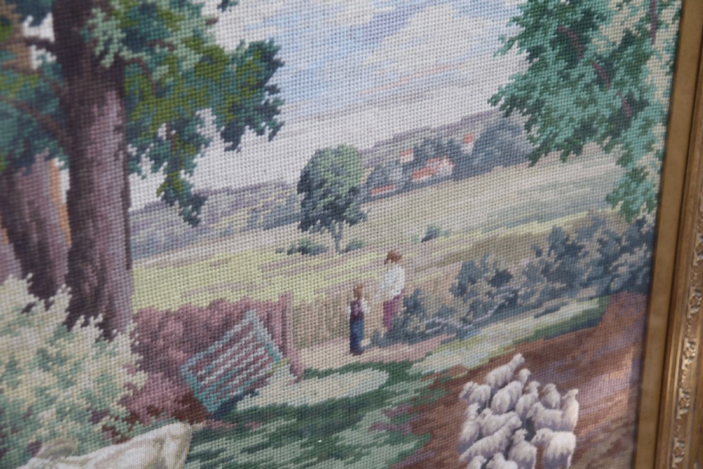 A large framed woolwork needlepoint tapestry depicting a pastoral landscape scene enclosed in a heavily ornamented giltwood frame. View XIII