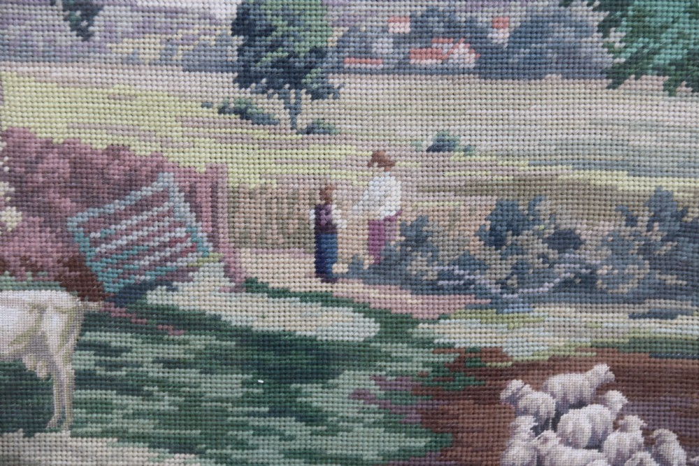 A large framed woolwork needlepoint tapestry depicting a pastoral landscape scene enclosed in a heavily ornamented giltwood frame. View XVII