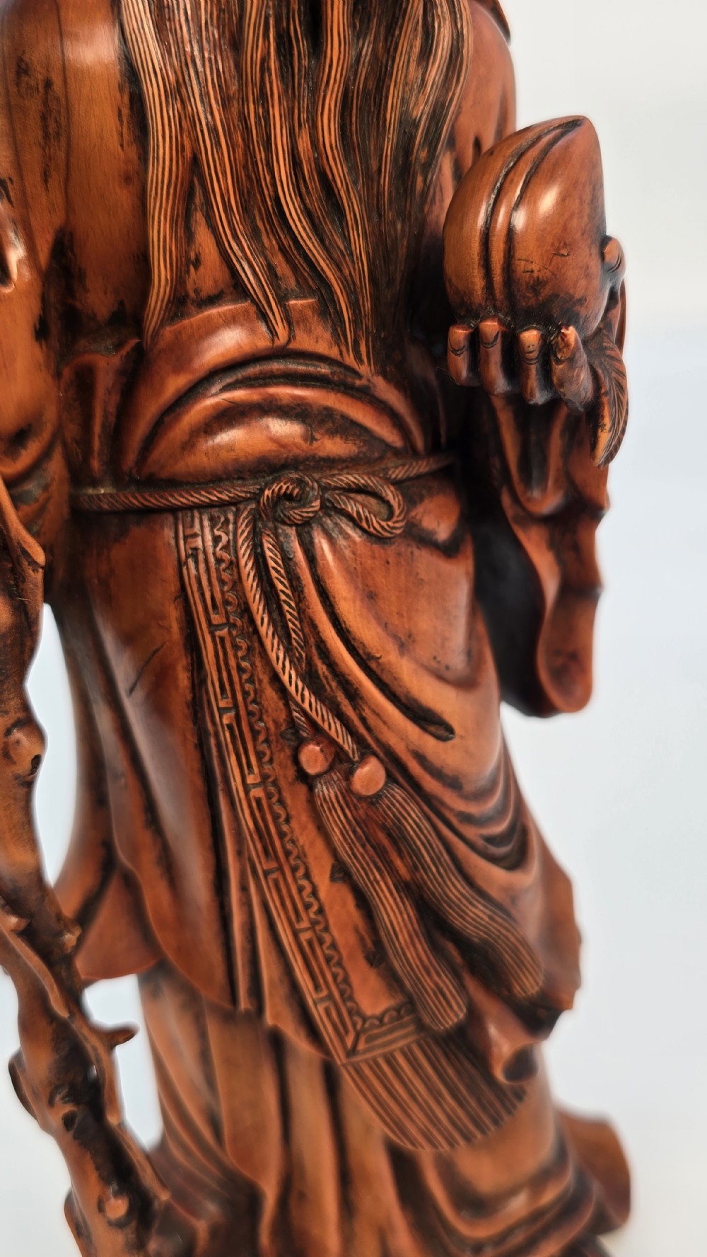 A Japanese carved boxwood okimono figure depicting Fukurokuju with a high forehead, long beard, flowing robes, and holding a gnarled staff. View XV
