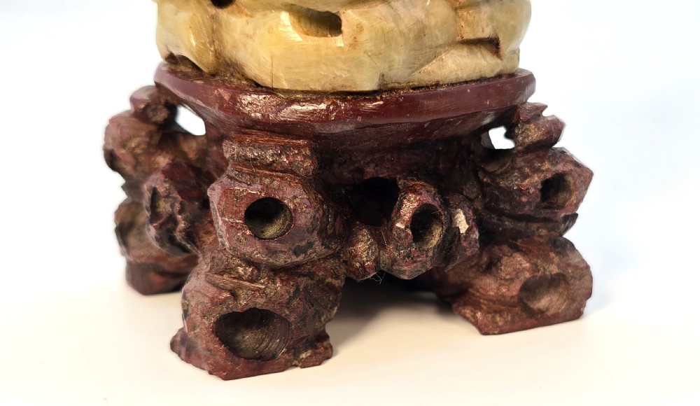 A pair of carved pale green stone Chinese figures representing a fisherman with a fish and a maiden with a fan, displayed on dark wood bases. View XX