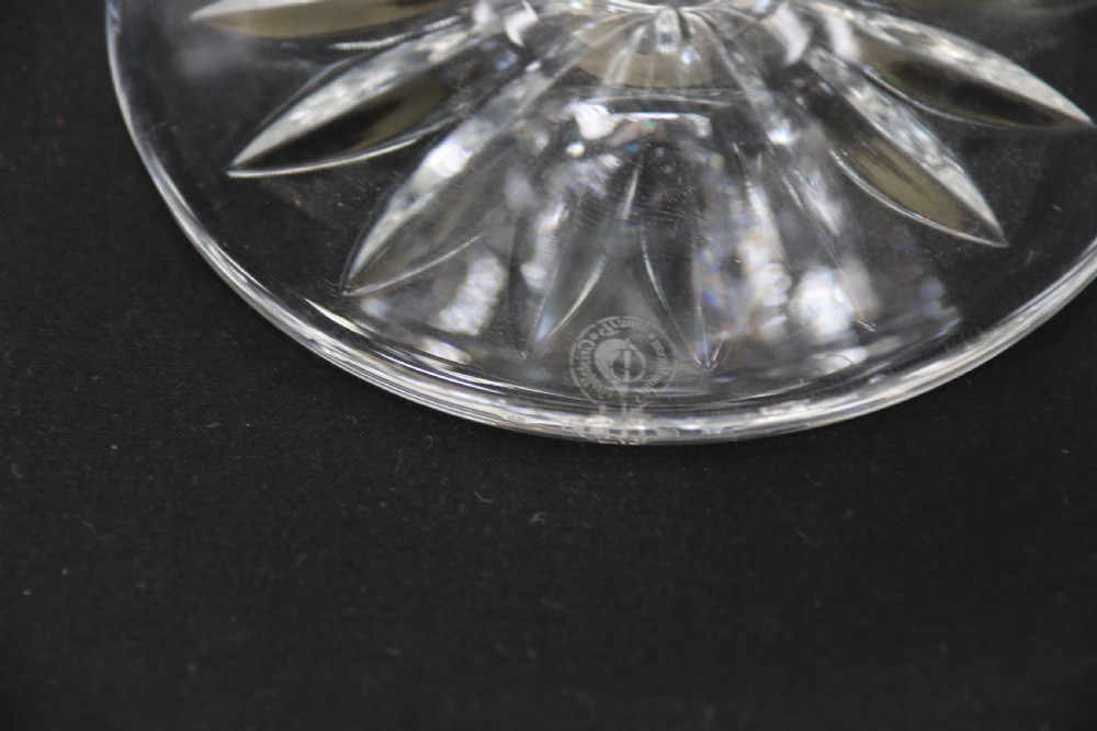 A set of five cut crystal perfume display bottles with faceted stoppers, diamond cut bodies, and silver spigots. View VII