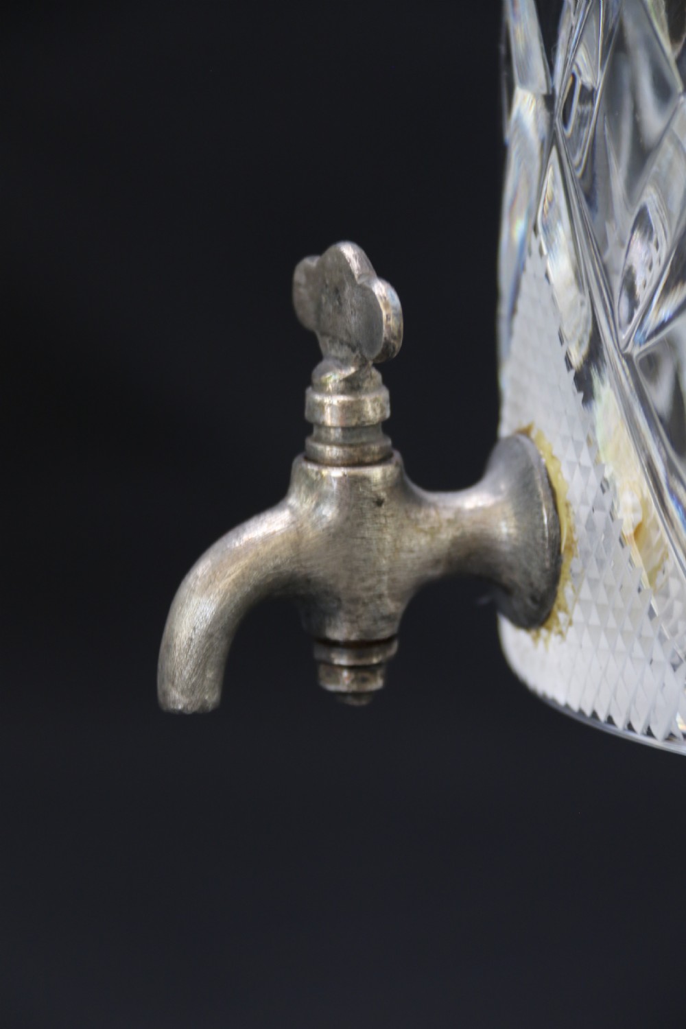 A set of five cut crystal perfume display bottles with faceted stoppers, diamond cut bodies, and silver spigots. View VIII