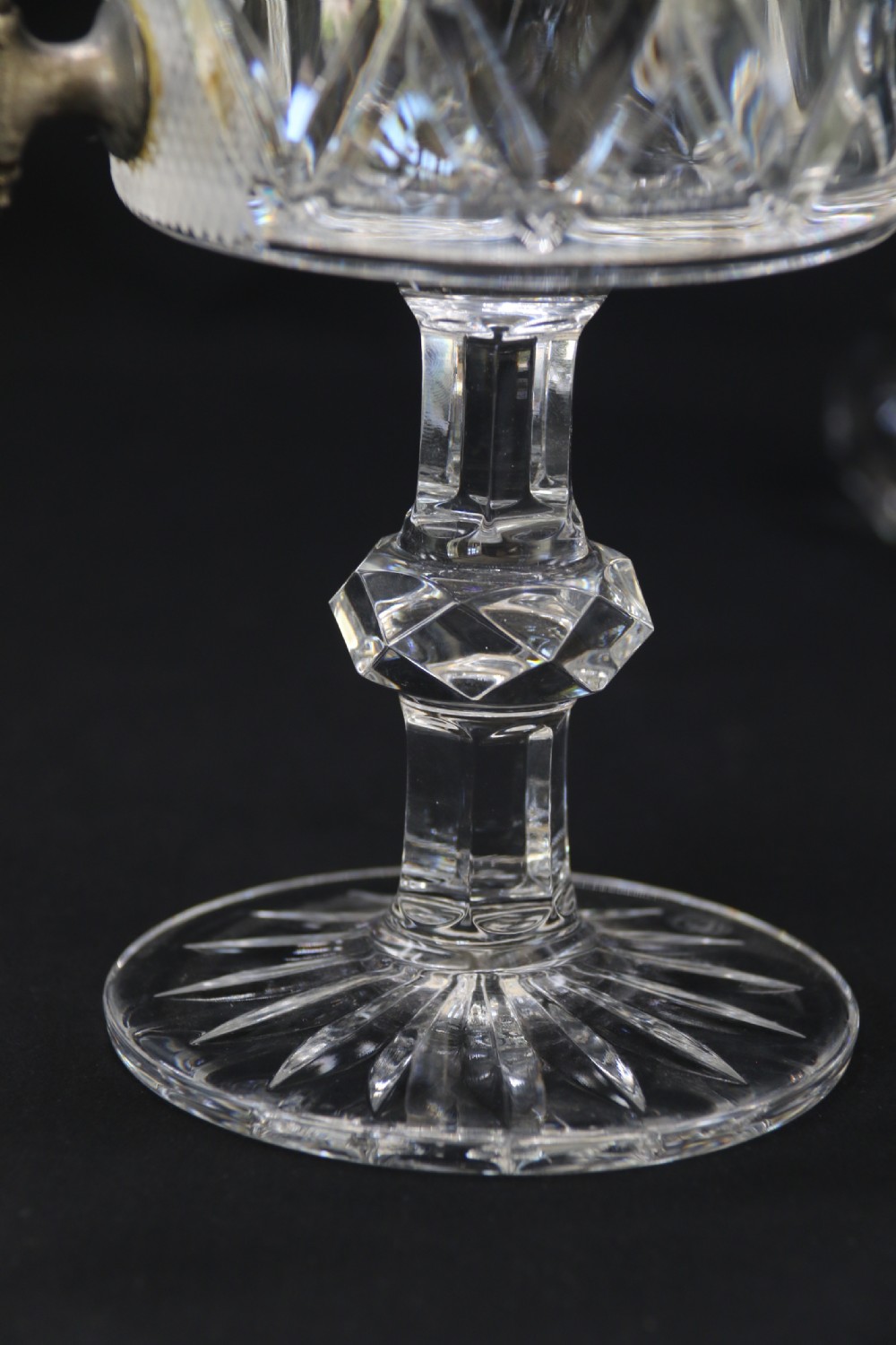A set of five cut crystal perfume display bottles with faceted stoppers, diamond cut bodies, and silver spigots. View IX