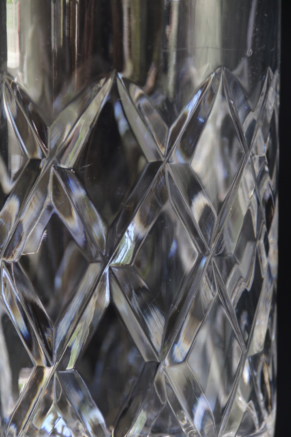 A set of five cut crystal perfume display bottles with faceted stoppers, diamond cut bodies, and silver spigots. View XI