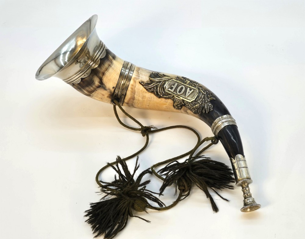A Victorian natural horn featuring silver-plated mounts, an engraved foliage crest with the letters AOF, and dark braided tassels. View V