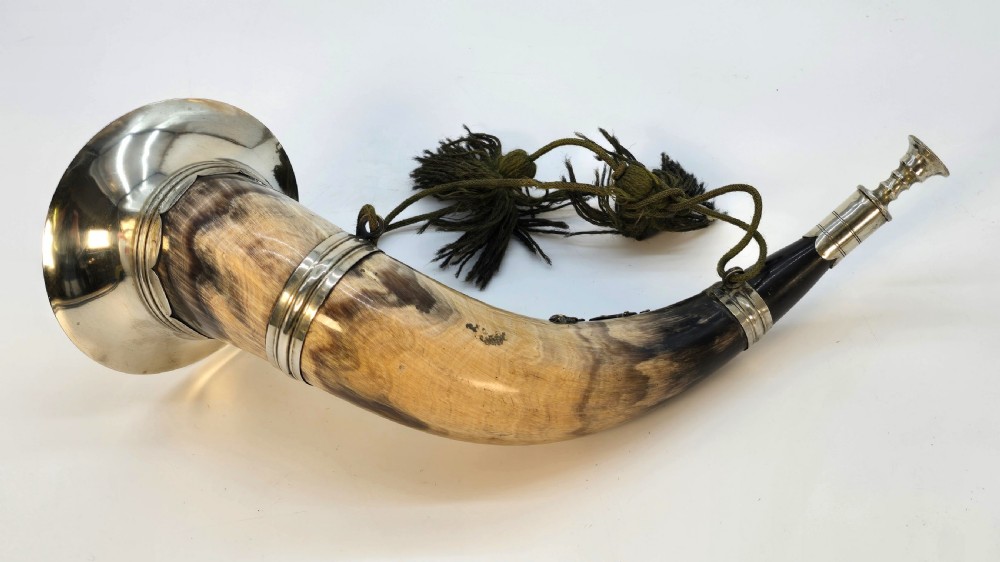 A Victorian natural horn featuring silver-plated mounts, an engraved foliage crest with the letters AOF, and dark braided tassels. View XII