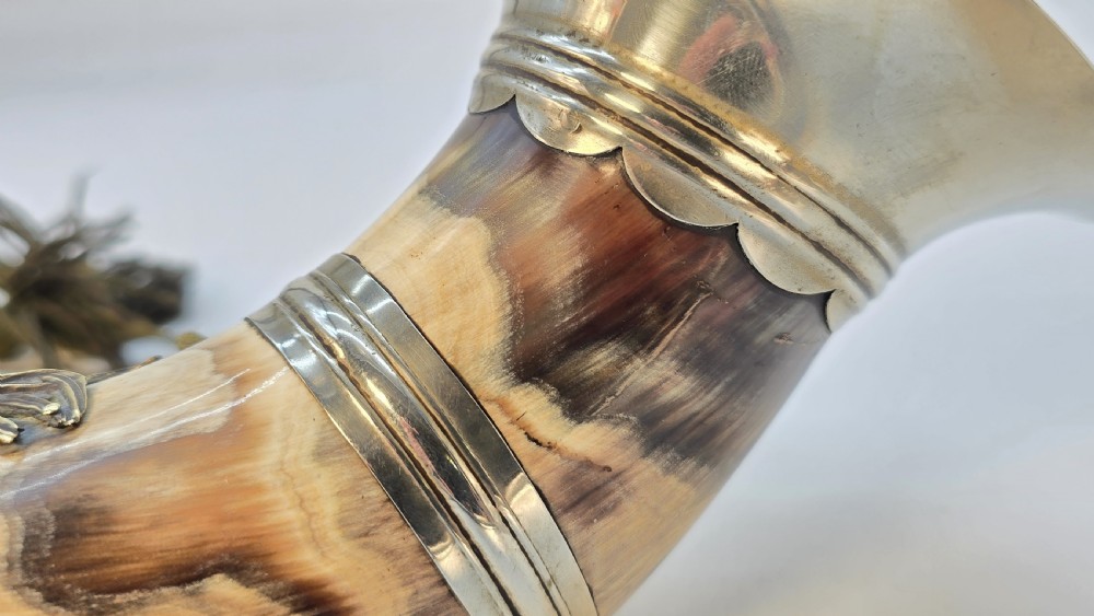 A Victorian natural horn featuring silver-plated mounts, an engraved foliage crest with the letters AOF, and dark braided tassels. View XIII