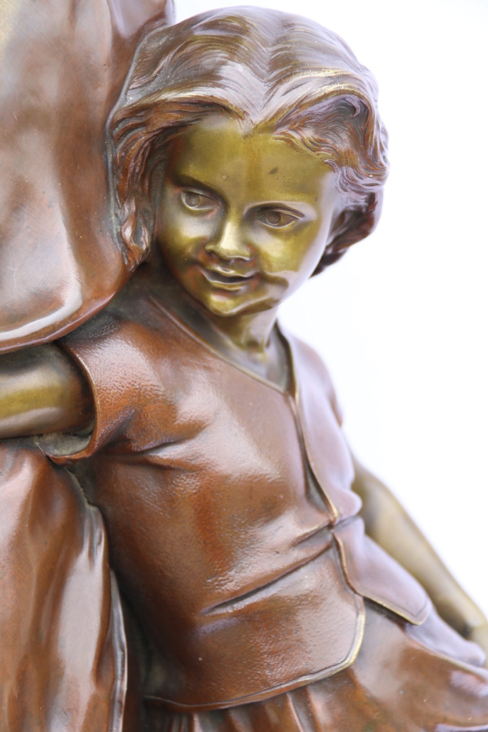 A late nineteenth-century patinated bronze sculpture depicting a woman holding a spinning distaff beside a young child clinging to her skirt. View III
