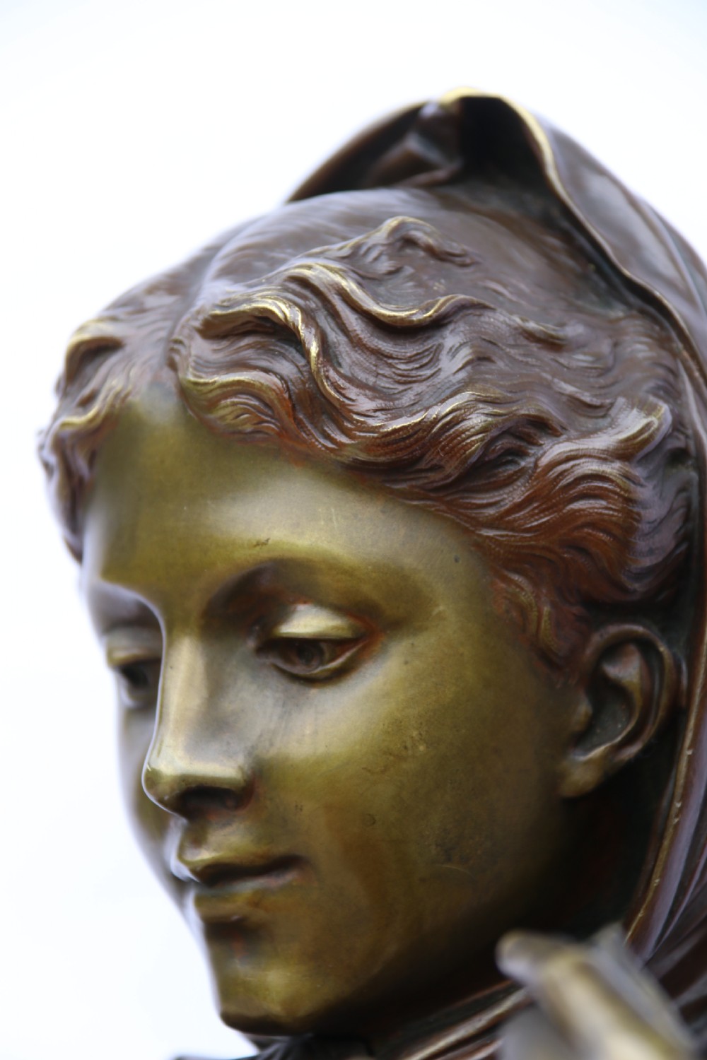 A late nineteenth-century patinated bronze sculpture depicting a woman holding a spinning distaff beside a young child clinging to her skirt. View XIII