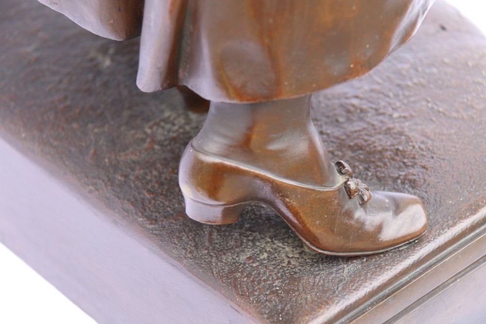 A late nineteenth-century patinated bronze sculpture depicting a woman holding a spinning distaff beside a young child clinging to her skirt. View XIV