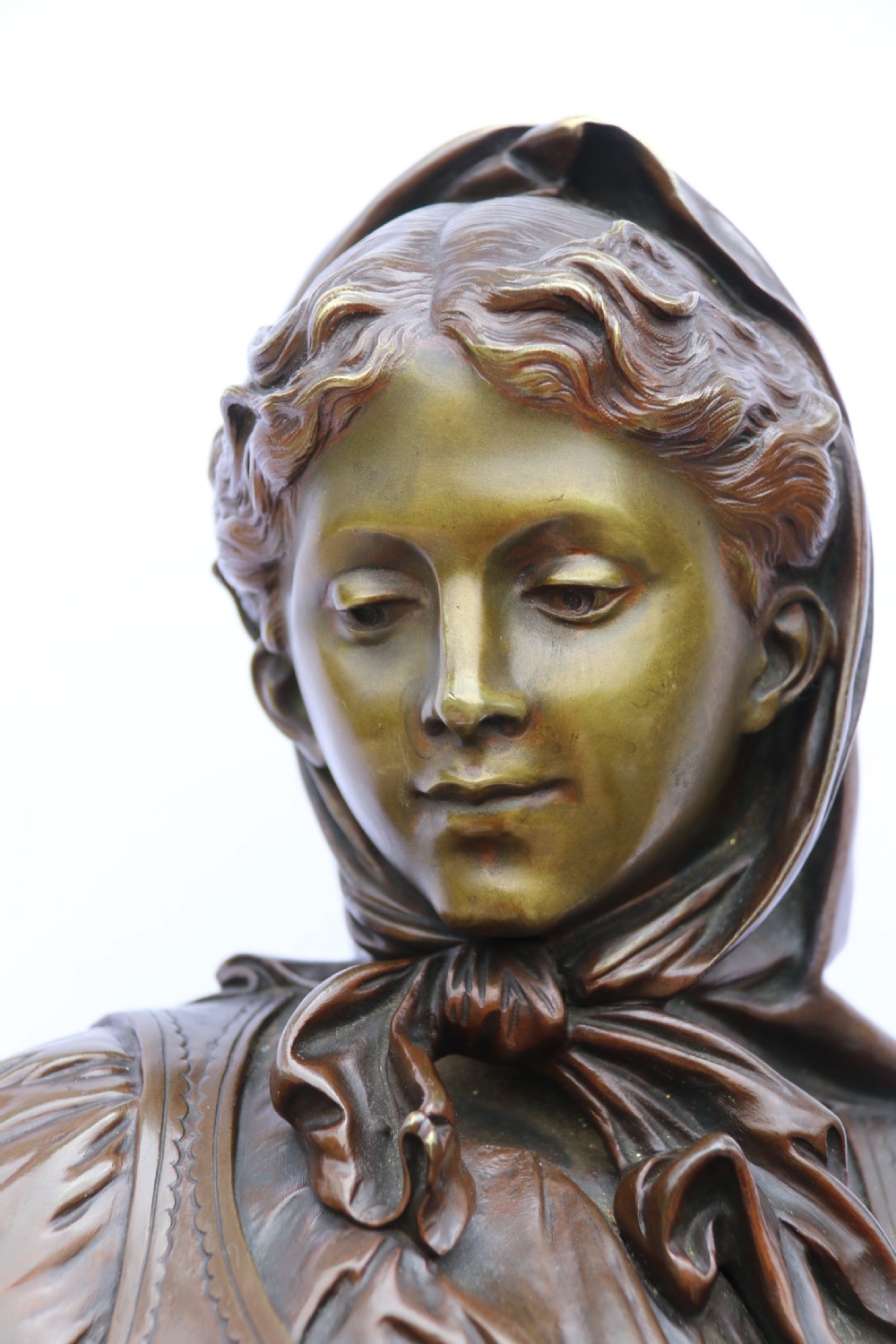 A late nineteenth-century patinated bronze sculpture depicting a woman holding a spinning distaff beside a young child clinging to her skirt. View XVI