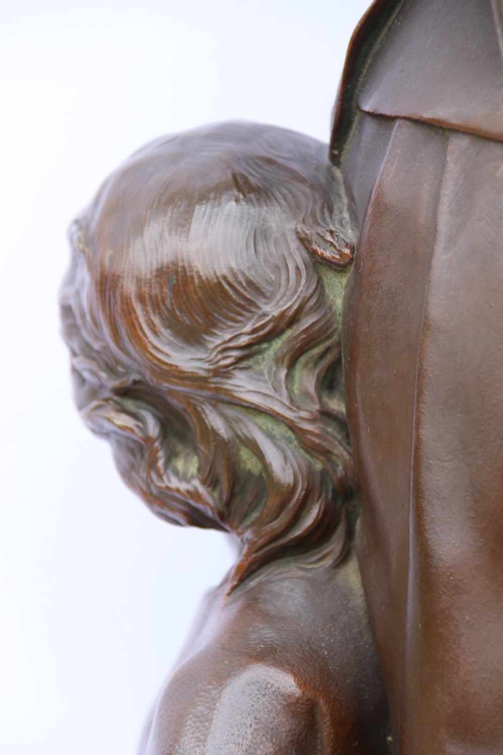 A late nineteenth-century patinated bronze sculpture depicting a woman holding a spinning distaff beside a young child clinging to her skirt. View XVIII