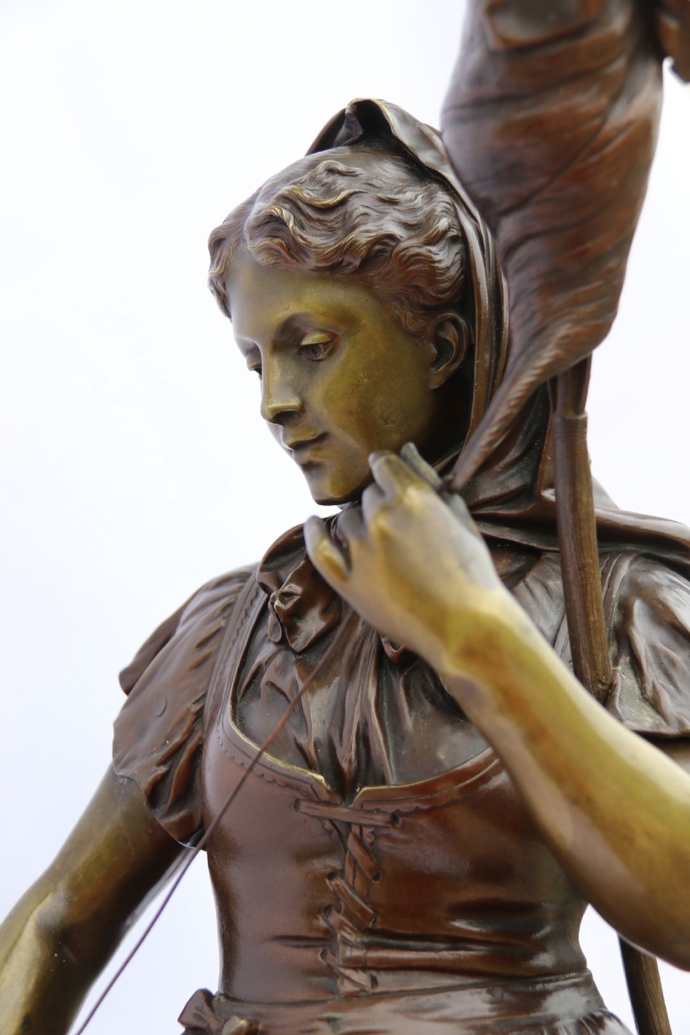 A late nineteenth-century patinated bronze sculpture depicting a woman holding a spinning distaff beside a young child clinging to her skirt. View XXII