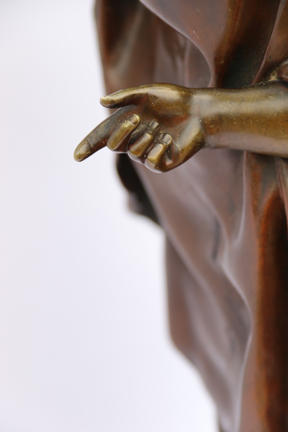 A late nineteenth-century patinated bronze sculpture depicting a woman holding a spinning distaff beside a young child clinging to her skirt. View XXIV
