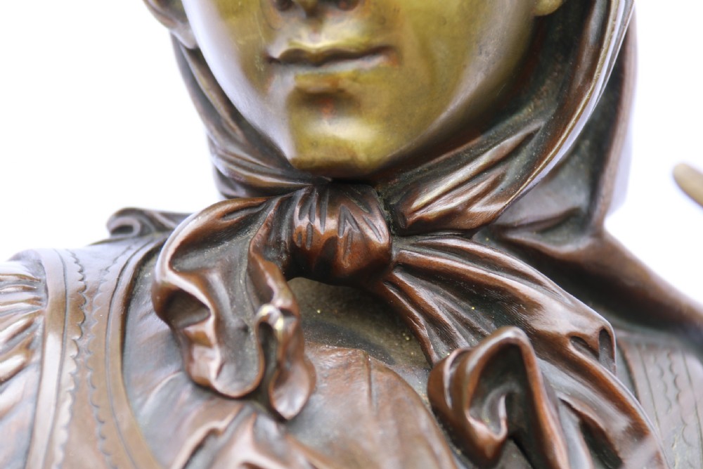 A late nineteenth-century patinated bronze sculpture depicting a woman holding a spinning distaff beside a young child clinging to her skirt. View XXVII