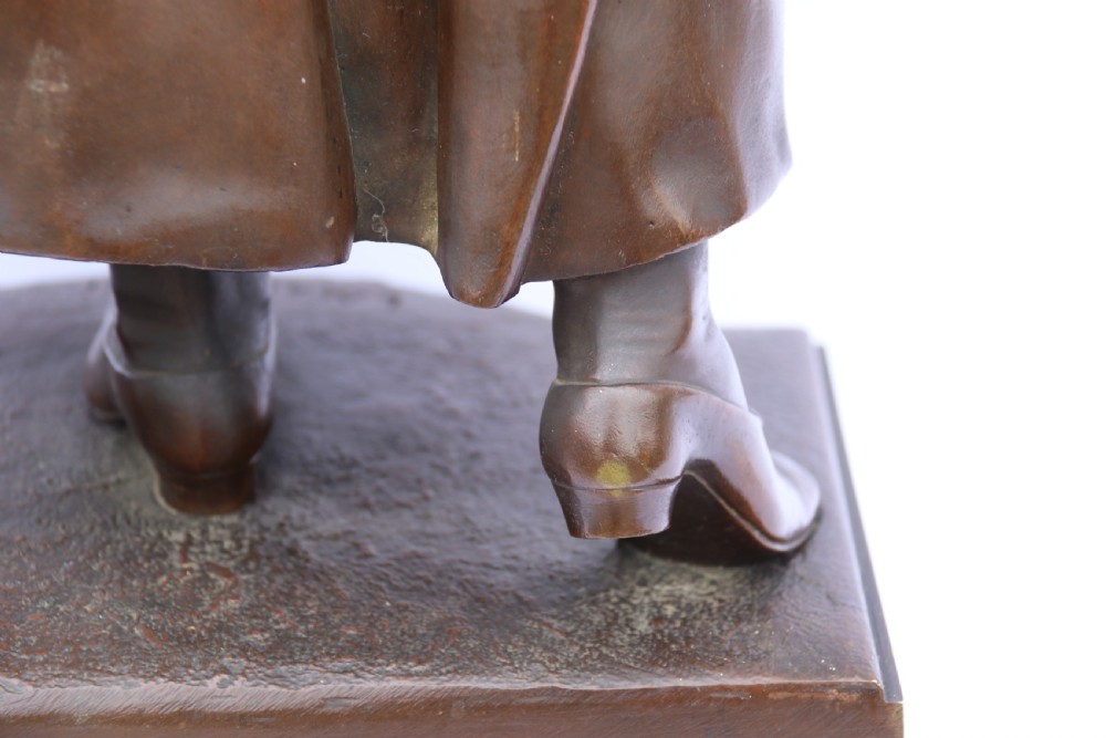 A late nineteenth-century patinated bronze sculpture depicting a woman holding a spinning distaff beside a young child clinging to her skirt. View XXXI