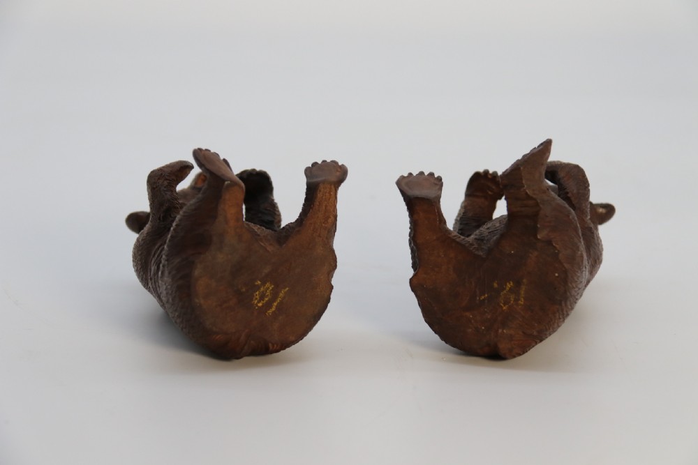 A pair of hand-carved dark brown linden wood Black Forest bears depicted sitting on their haunches with open jaws. View XIII