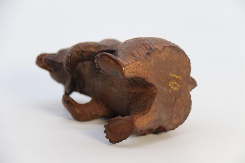 A pair of hand-carved dark brown linden wood Black Forest bears depicted sitting on their haunches with open jaws. View XVII