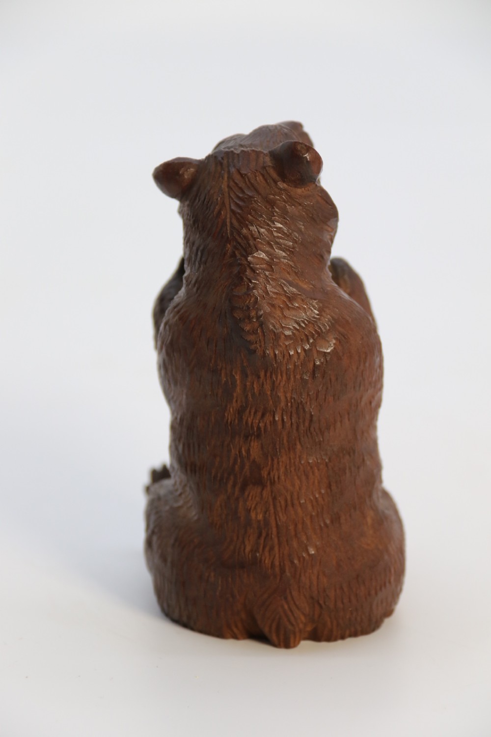 A pair of hand-carved dark brown linden wood Black Forest bears depicted sitting on their haunches with open jaws. View XXIV