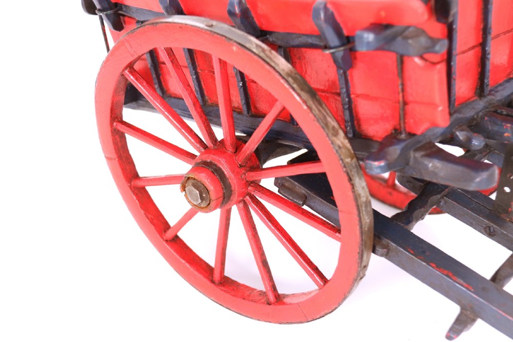 A detailed handmade wooden scale model of an 18th-century farm cart featuring red painted sides, dark blue framing and shafts, and spoked red wheels. View XI