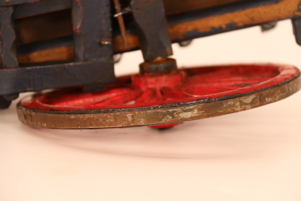 A detailed handmade wooden scale model of an 18th-century farm cart featuring red painted sides, dark blue framing and shafts, and spoked red wheels. View XIV