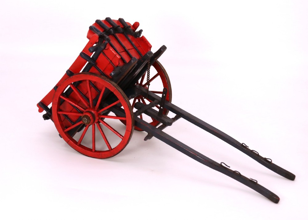A detailed handmade wooden scale model of an 18th-century farm cart featuring red painted sides, dark blue framing and shafts, and spoked red wheels. View XV