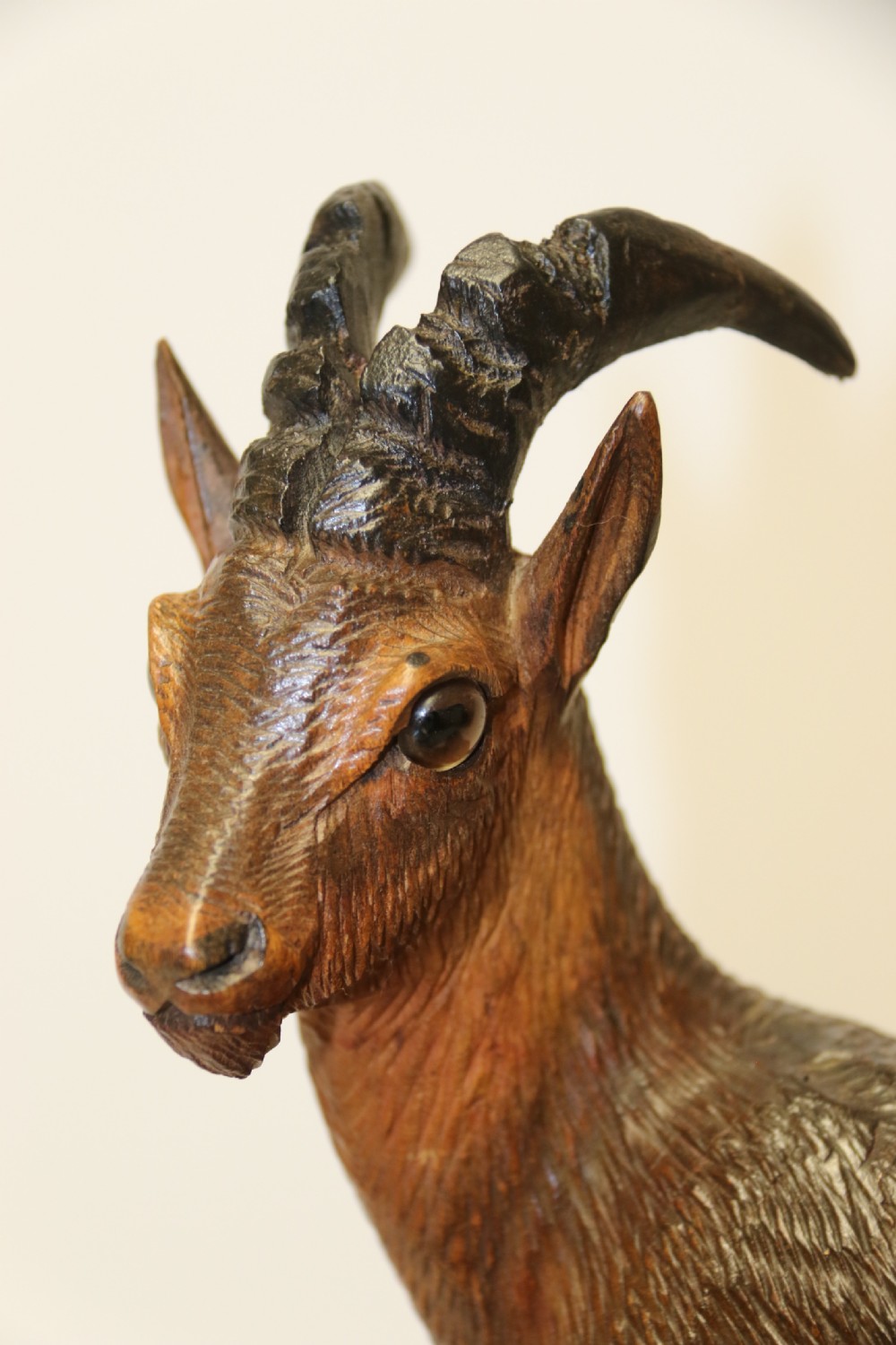 A pair of hand-carved wooden sculptures depicting ibex and chamois with offspring on carved rocky bases. View VII