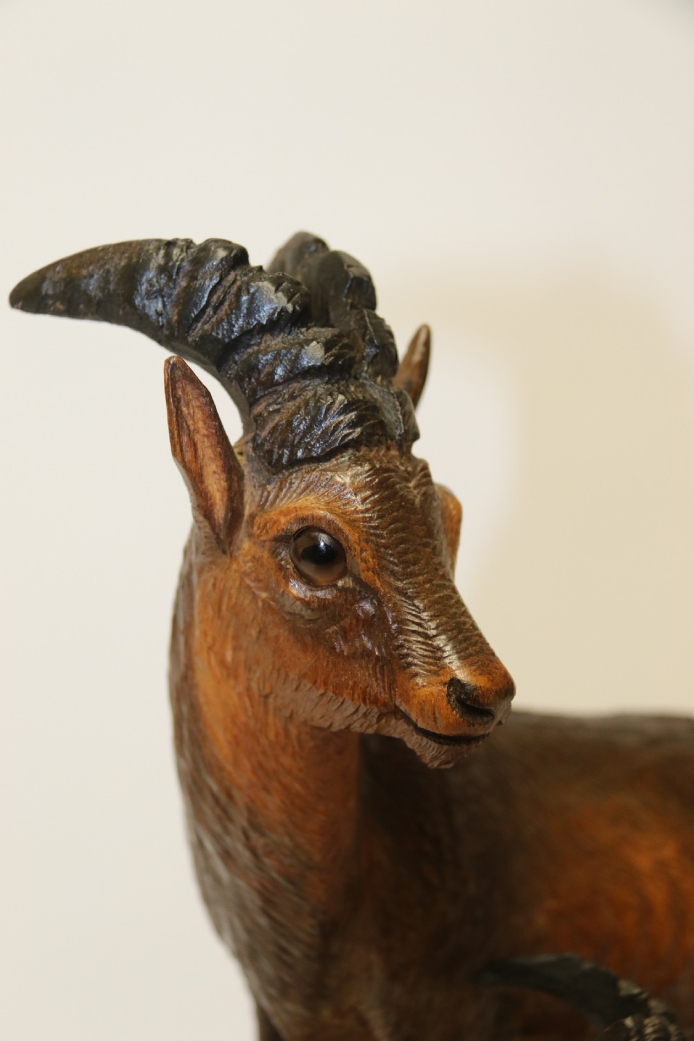 A pair of hand-carved wooden sculptures depicting ibex and chamois with offspring on carved rocky bases. View VIII