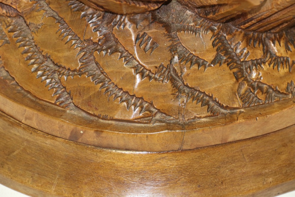 A pair of hand-carved wooden sculptures depicting ibex and chamois with offspring on carved rocky bases. View XXIII
