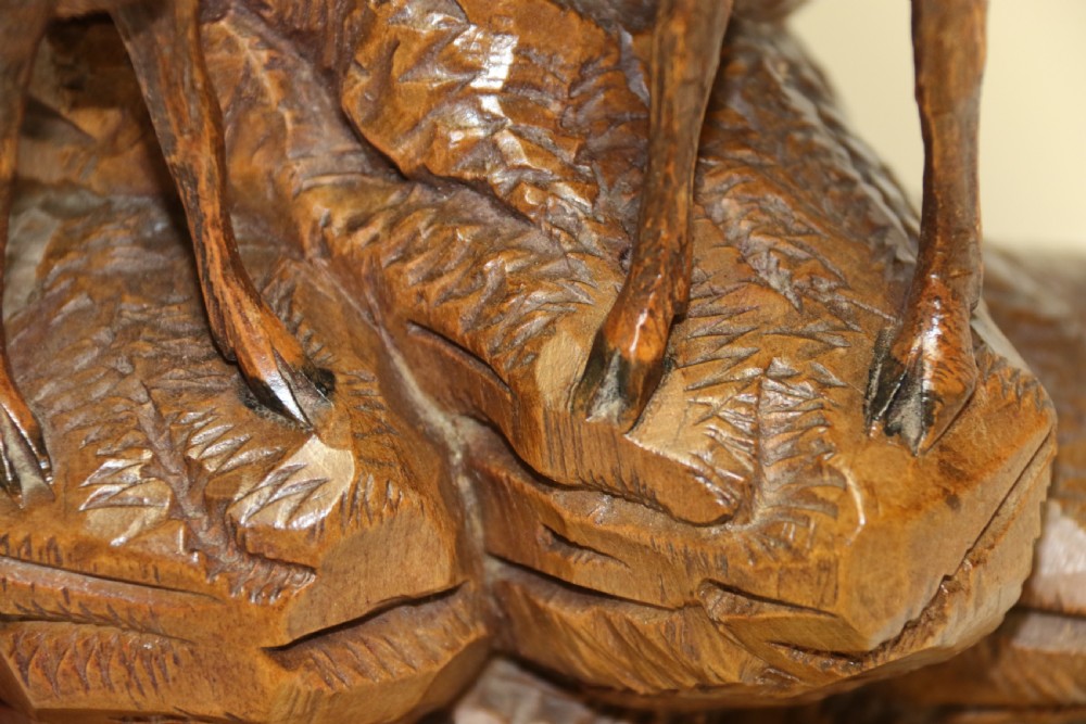 A pair of hand-carved wooden sculptures depicting ibex and chamois with offspring on carved rocky bases. View XXIV