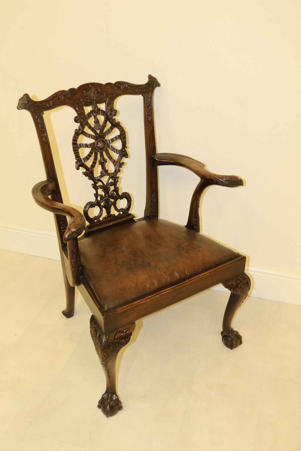 A late 19th-century Chippendale style mahogany armchair featuring carved eagle head terminals, a pierced back splat, brown leather seat, and cabriole legs with claw and ball feet. View III