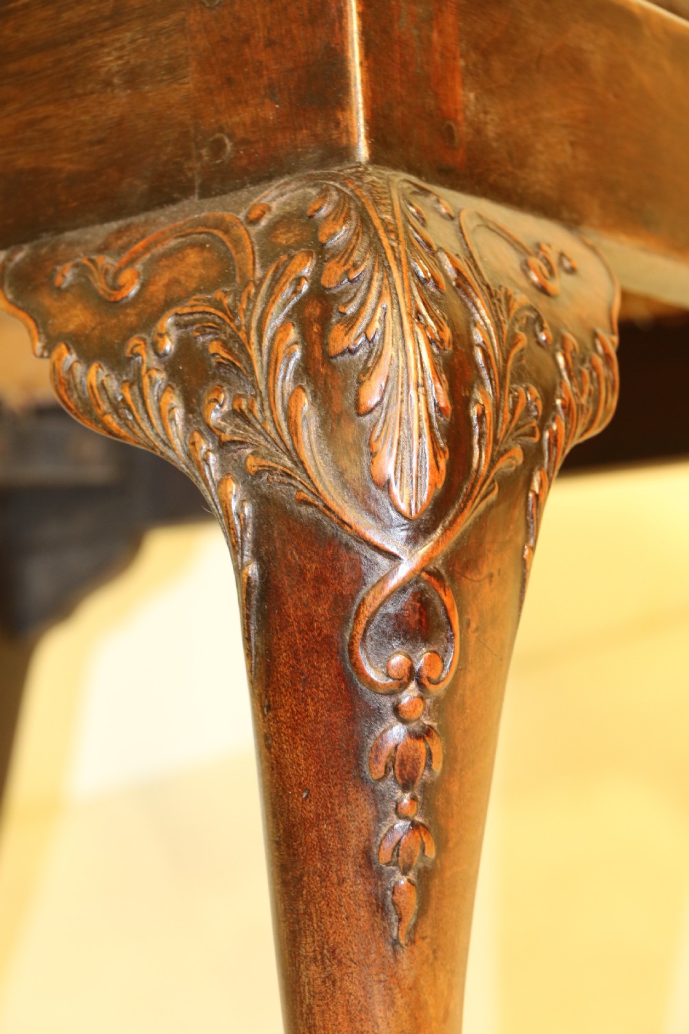 A late 19th-century Chippendale style mahogany armchair featuring carved eagle head terminals, a pierced back splat, brown leather seat, and cabriole legs with claw and ball feet. View VII