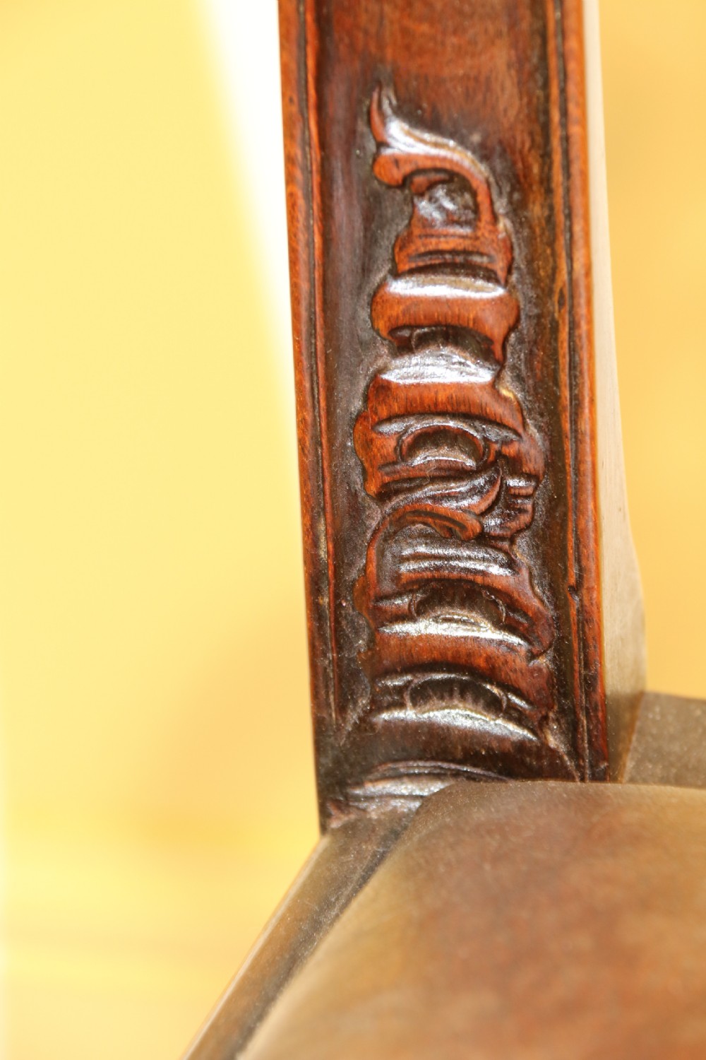 A late 19th-century Chippendale style mahogany armchair featuring carved eagle head terminals, a pierced back splat, brown leather seat, and cabriole legs with claw and ball feet. View VIII