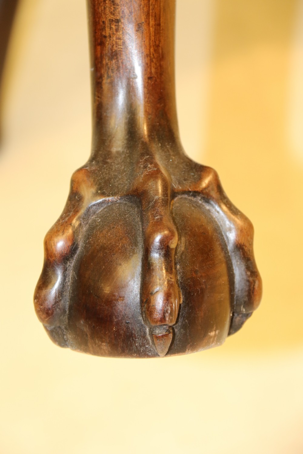 A late 19th-century Chippendale style mahogany armchair featuring carved eagle head terminals, a pierced back splat, brown leather seat, and cabriole legs with claw and ball feet. View IX