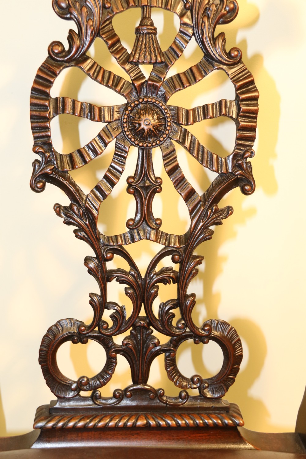 A late 19th-century Chippendale style mahogany armchair featuring carved eagle head terminals, a pierced back splat, brown leather seat, and cabriole legs with claw and ball feet. View XI