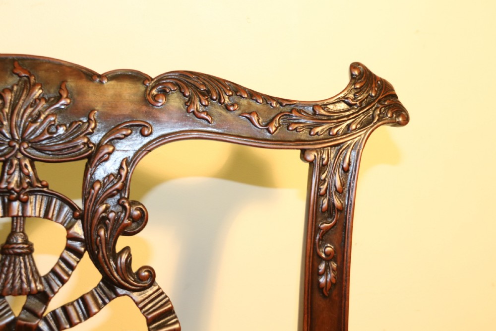 A late 19th-century Chippendale style mahogany armchair featuring carved eagle head terminals, a pierced back splat, brown leather seat, and cabriole legs with claw and ball feet. View XII