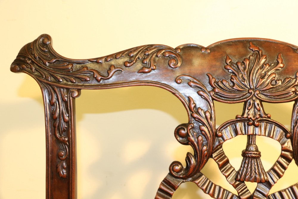 A late 19th-century Chippendale style mahogany armchair featuring carved eagle head terminals, a pierced back splat, brown leather seat, and cabriole legs with claw and ball feet. View XIII