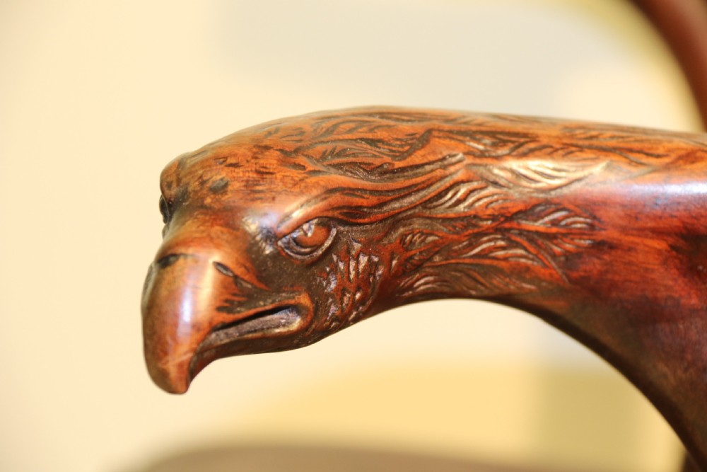 A late 19th-century Chippendale style mahogany armchair featuring carved eagle head terminals, a pierced back splat, brown leather seat, and cabriole legs with claw and ball feet. View XIV